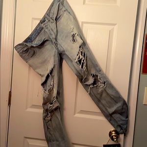 Ripped and distressed light wash tomboy jeans